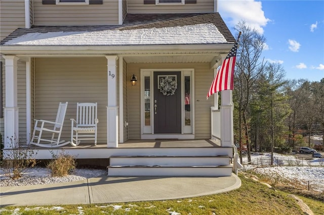 view of exterior entry with covered porch