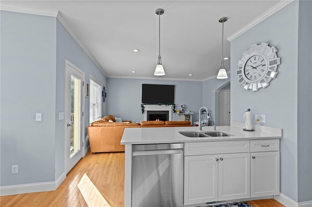 kitchen with stainless steel dishwasher, ornamental molding, sink, light hardwood / wood-style flooring, and white cabinetry