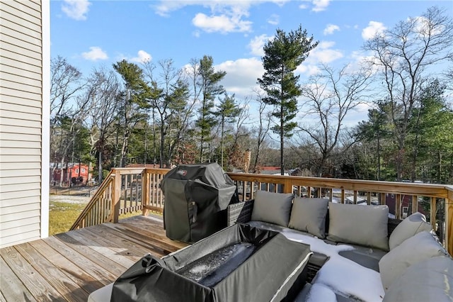 wooden deck with an outdoor living space and a grill