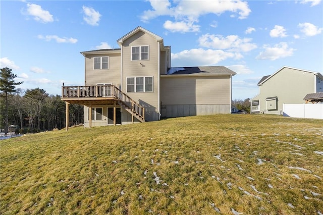 rear view of property with a yard and a deck