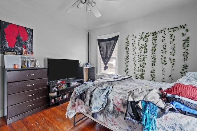 bedroom featuring ceiling fan and dark wood-type flooring