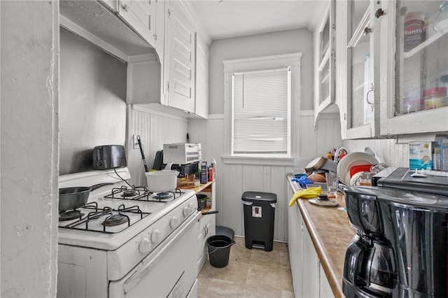 kitchen featuring white cabinetry and white range with gas stovetop