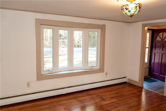 foyer entrance with baseboard heating and dark hardwood / wood-style floors