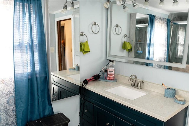 bathroom with vanity and ornamental molding