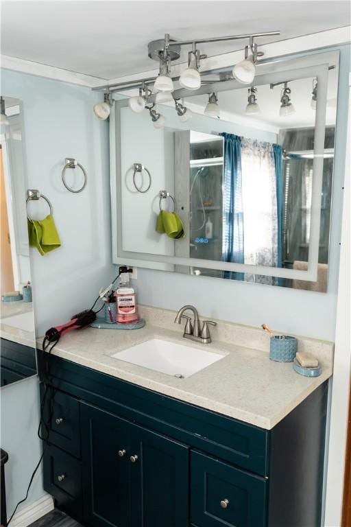 bathroom featuring a shower and vanity