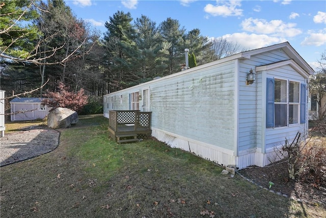 view of side of home with a yard