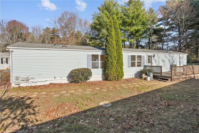 exterior space with a wooden deck and a front lawn