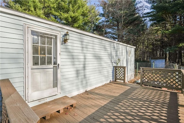 wooden terrace with a storage shed