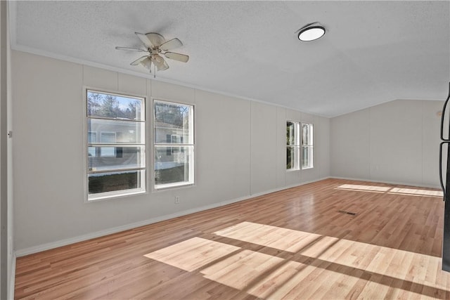 interior space with ceiling fan, light hardwood / wood-style flooring, a textured ceiling, and ornamental molding