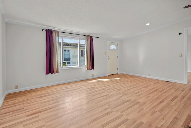 unfurnished room with light wood-type flooring and ornamental molding