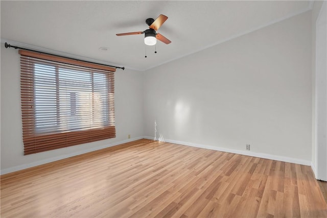 empty room with ceiling fan, light hardwood / wood-style floors, and crown molding