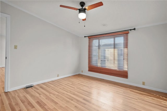 empty room featuring ceiling fan, light hardwood / wood-style floors, and ornamental molding