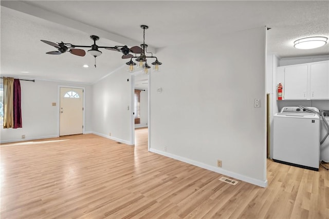 unfurnished living room featuring a textured ceiling, ceiling fan, washer / dryer, light hardwood / wood-style floors, and lofted ceiling