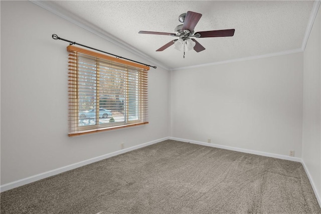 carpeted empty room with a textured ceiling, vaulted ceiling, ceiling fan, and ornamental molding