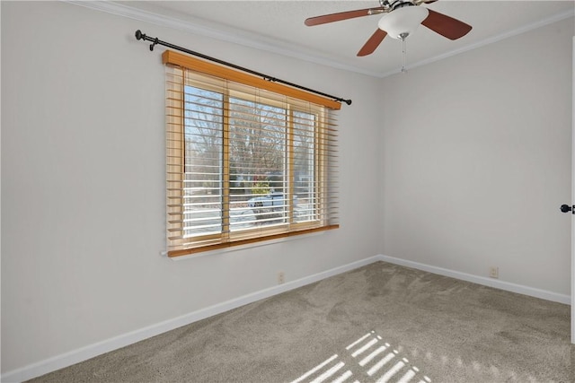 carpeted spare room featuring ceiling fan and crown molding