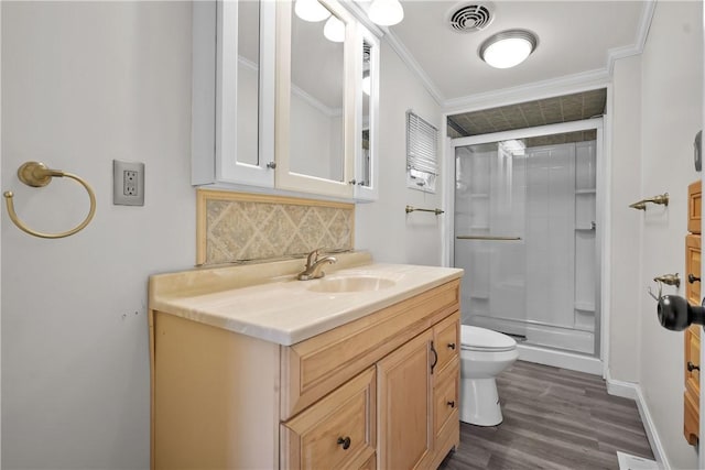 bathroom featuring vanity, crown molding, hardwood / wood-style flooring, decorative backsplash, and an enclosed shower