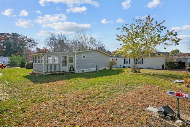 back of property featuring a lawn