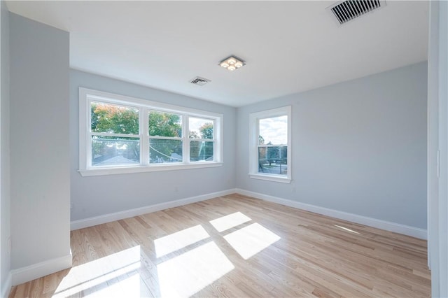 spare room with light hardwood / wood-style floors