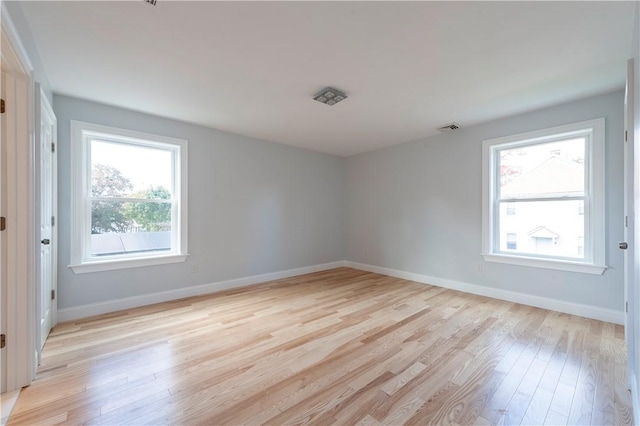 unfurnished room with light wood-type flooring