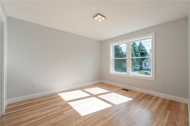 spare room featuring light wood-type flooring