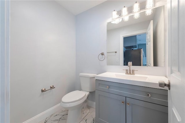 bathroom featuring toilet and vanity