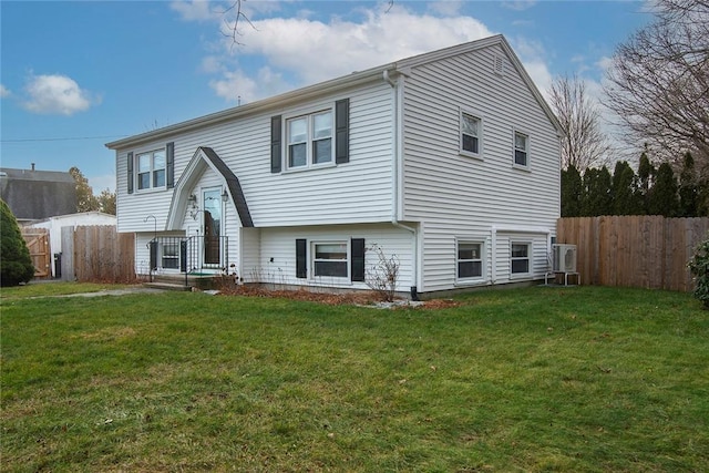 rear view of house featuring a yard