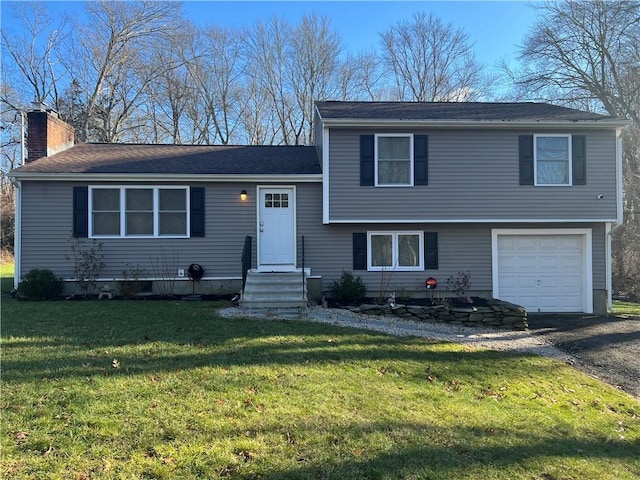 split level home with a front yard and a garage