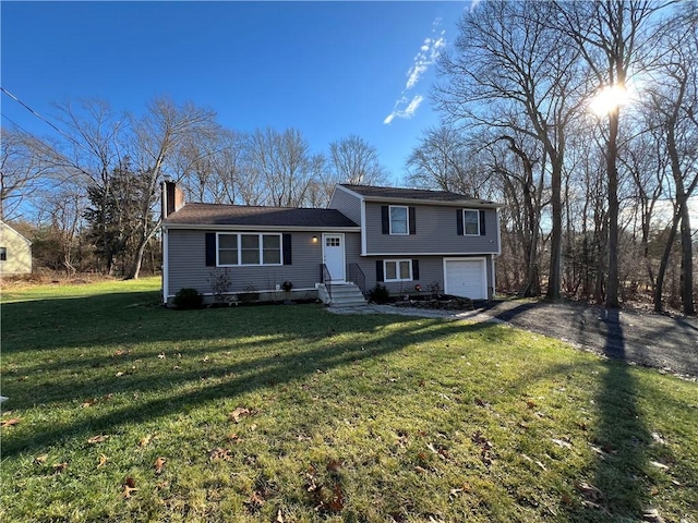 tri-level home with a front yard and a garage