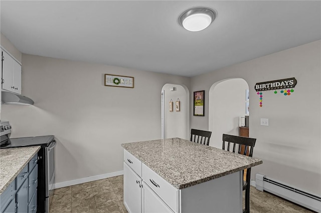 kitchen featuring a kitchen breakfast bar, a kitchen island, a baseboard heating unit, electric range, and white cabinetry