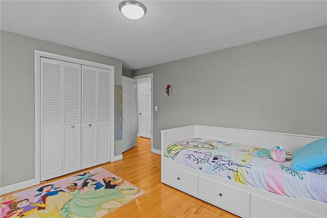 bedroom with wood-type flooring and a closet