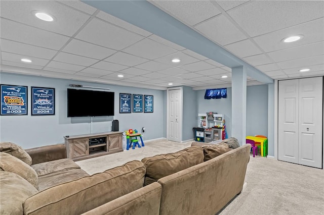 carpeted living room featuring a paneled ceiling