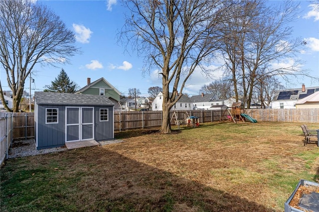 view of yard with a playground and a shed