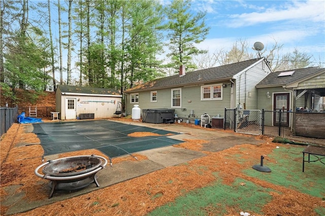 back of property with basketball court and an outdoor structure