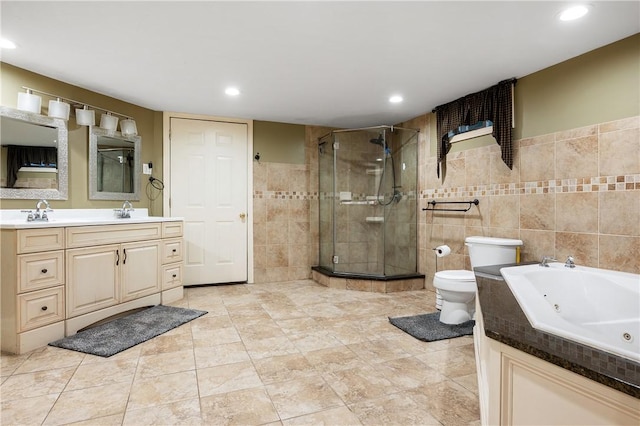 full bathroom with toilet, vanity, tile walls, and independent shower and bath