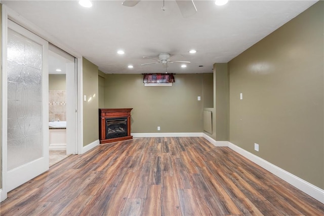 unfurnished living room with ceiling fan and dark hardwood / wood-style floors