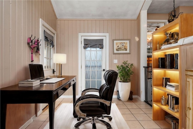 tiled office space featuring wood walls