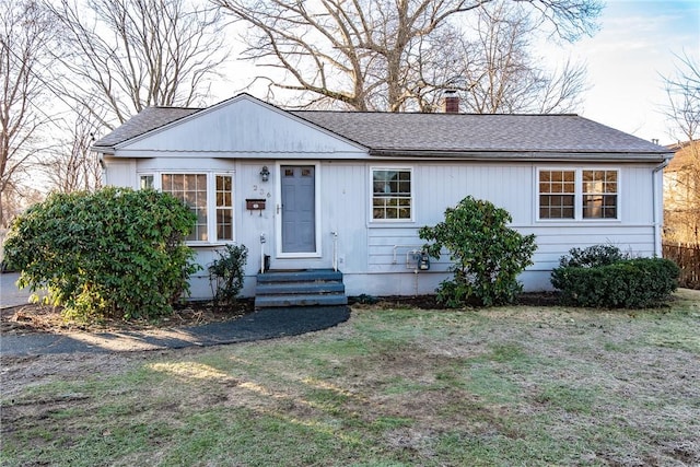 ranch-style home featuring a front yard