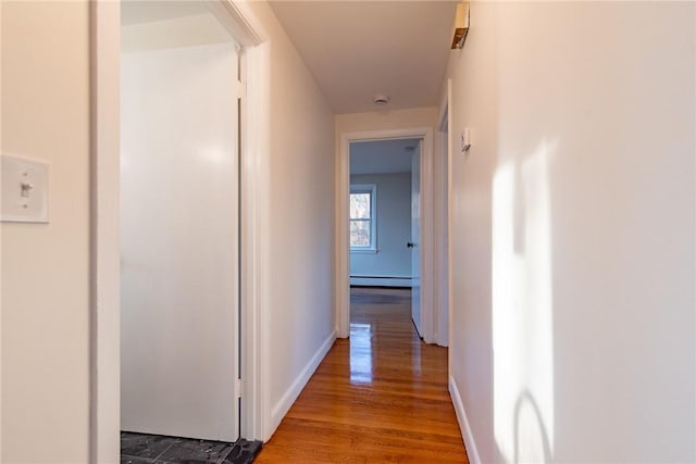 hall featuring hardwood / wood-style floors and a baseboard radiator