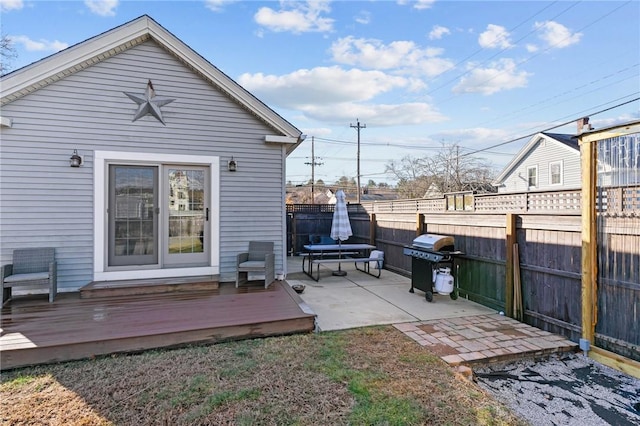 back of property featuring a deck and a patio area