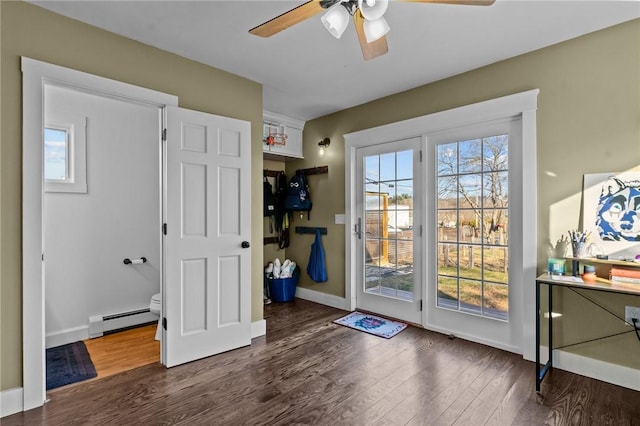 doorway to outside featuring a baseboard radiator, ceiling fan, and dark wood-type flooring