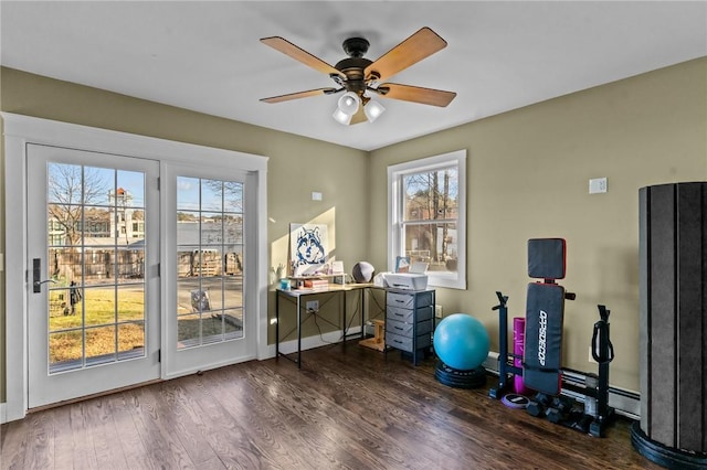 workout room with dark hardwood / wood-style floors, plenty of natural light, and ceiling fan