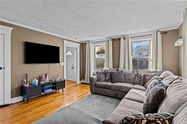 living room featuring cooling unit, wood-type flooring, a textured ceiling, and ornamental molding