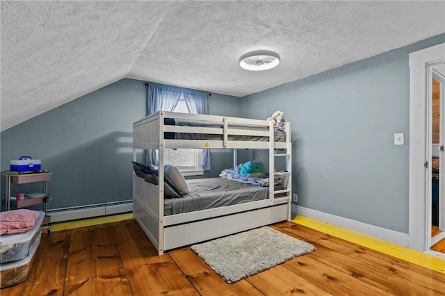 bedroom with hardwood / wood-style flooring, a textured ceiling, a baseboard radiator, and vaulted ceiling