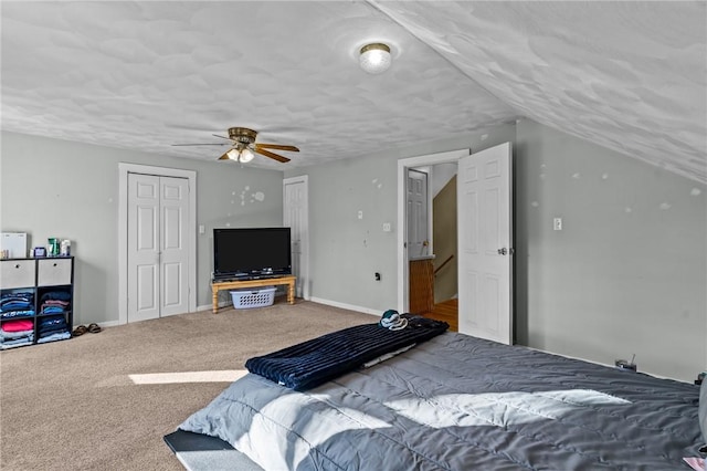 bedroom with vaulted ceiling, ceiling fan, carpet, and a textured ceiling