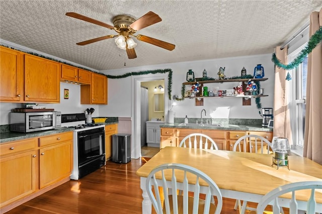 kitchen featuring ceiling fan, sink, dark hardwood / wood-style flooring, a textured ceiling, and white gas range oven