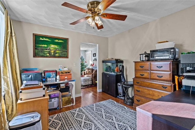 bedroom with ceiling fan and dark wood-type flooring