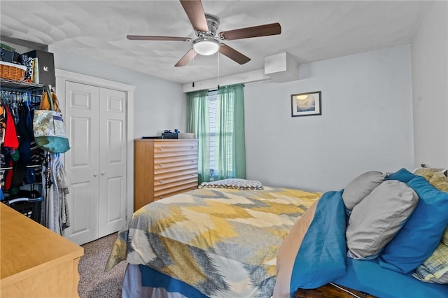 carpeted bedroom with ceiling fan and a closet