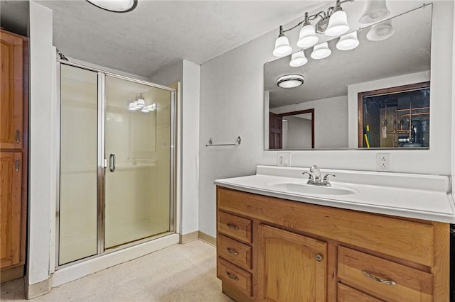 bathroom with vanity and a shower with shower door