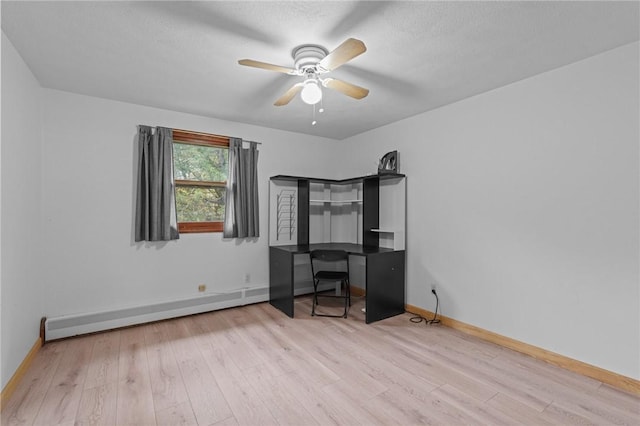 unfurnished office with light wood-type flooring, baseboard heating, and ceiling fan