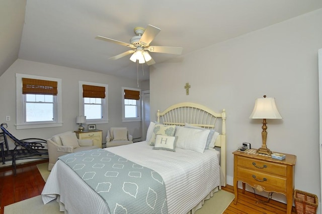 bedroom featuring hardwood / wood-style floors, vaulted ceiling, and ceiling fan